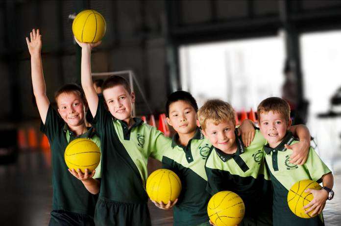 Students holding basketballs